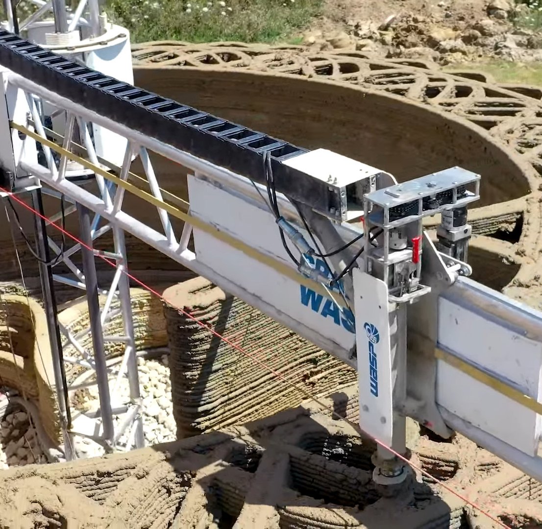 Robotic 3D printer arm building the walls of a sustainable house